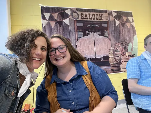 Two guests at the saloon backdrop