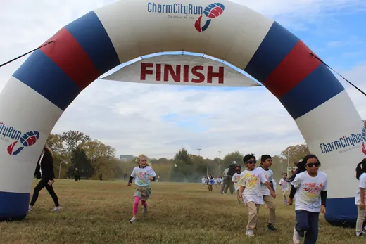 Through the finish arch, BeeFit 2025