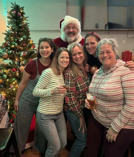 Santa and volunteers at the holiday social