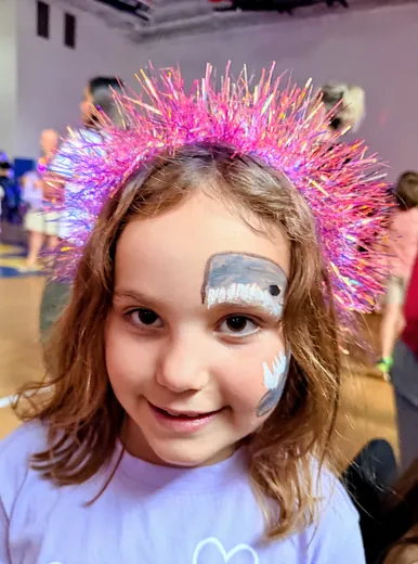 A pink headdress and fresh face paint