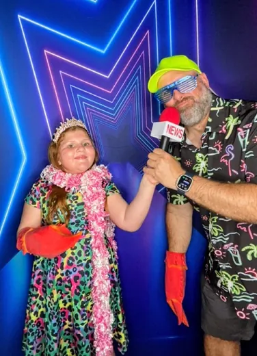 A news mic and a loud shirt