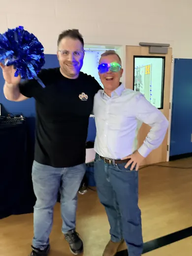 Organisers with pom-poms by the DJ booth